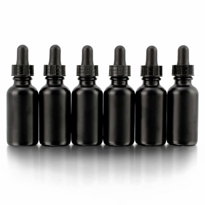 La bouteille en verre noire de l'oeil 30ml cosmétique avec le compte-gouttes se renversent non